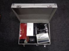 An aluminium camera case containing two Yashica FX-D cameras, assorted lenses to include Sigma,