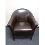 A faux leather tub chair.