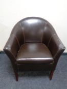 A faux leather tub chair.