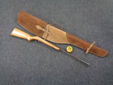 A 20th century air rifle, serial number CC22263, in suede rifle bag, together with a tin of .