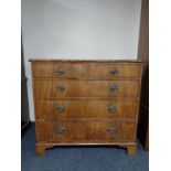 A George III style mahogany five drawer chest on bracket feet