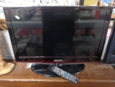 A Samsung 26'' LCD TV with remote and lead.