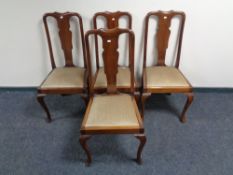 A set of four mahogany Queen Anne style dining chairs.