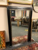 A 4' by 2' black and gold mirror