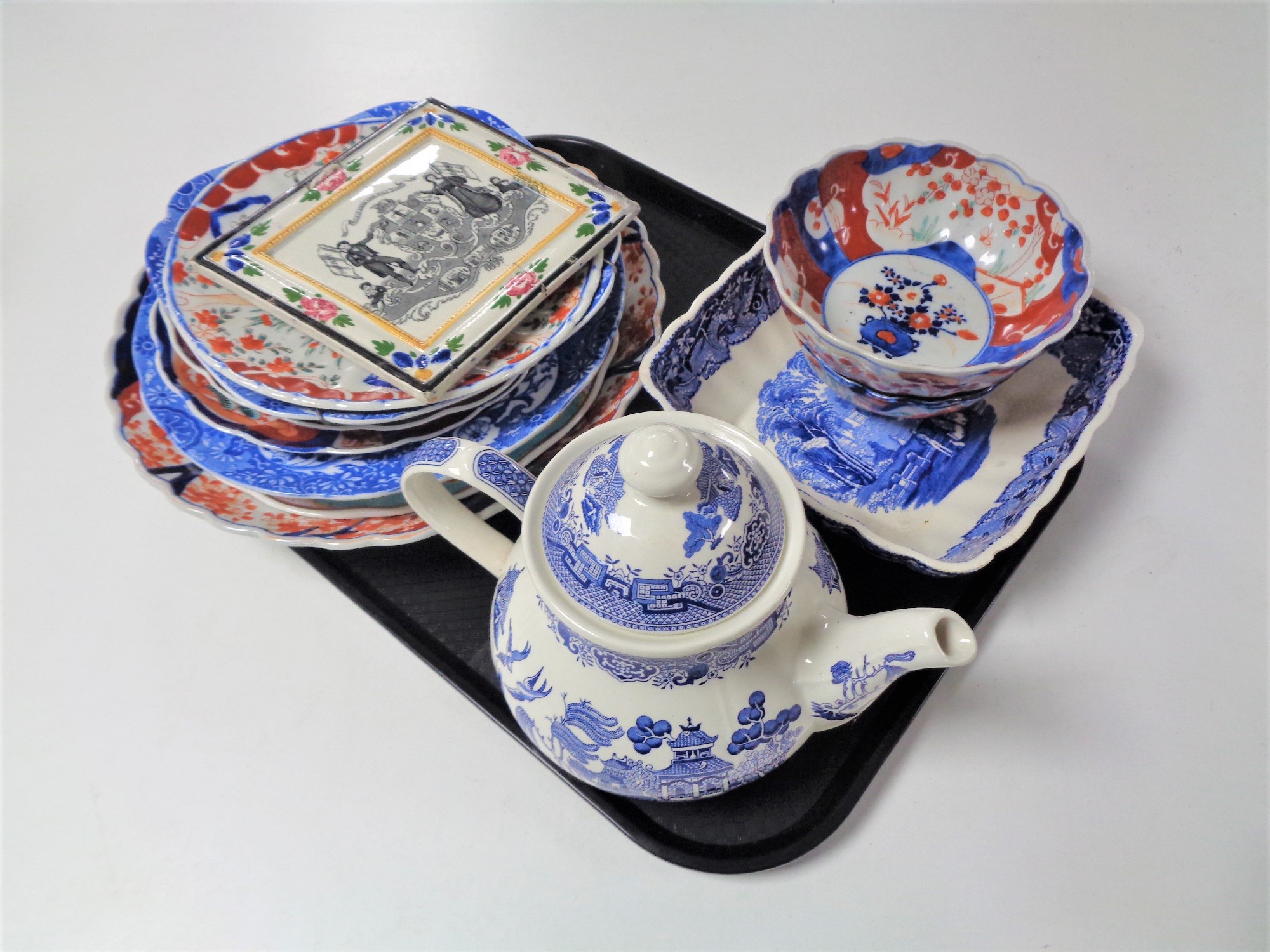 A tray of assorted Imari plates and bowls, blue and white teapot,