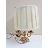 An antique French gilt three-way table lamp with shade.