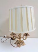 An antique French gilt three-way table lamp with shade.