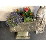 A weathered concrete planter on sandstone base, height 58 cm.