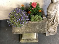 A weathered concrete planter on sandstone base, height 58 cm.