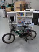 A boys Universal bike together with a play kitchen.