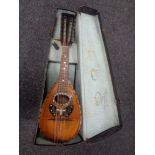 A twelve-string bowl backed mandolin with mother of pearl decoration in fitted case