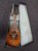 A twelve-string bowl backed mandolin with mother of pearl decoration in fitted case