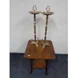 A walnut two tier occasional table together with a pair of brass smoker's stands.