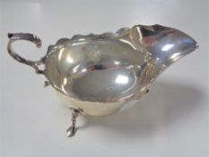 A Sheffield silver sauce boat on raised feet,