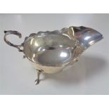 A Sheffield silver sauce boat on raised feet,