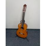 A Yamaha acoustic guitar on stand.