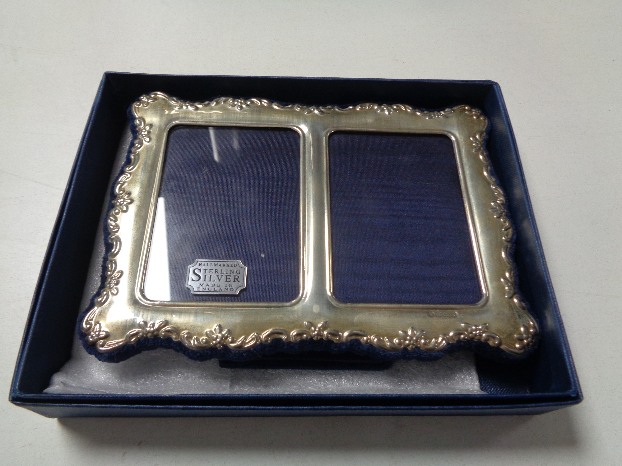 A boxed Sheffield silver twin photograph frame,