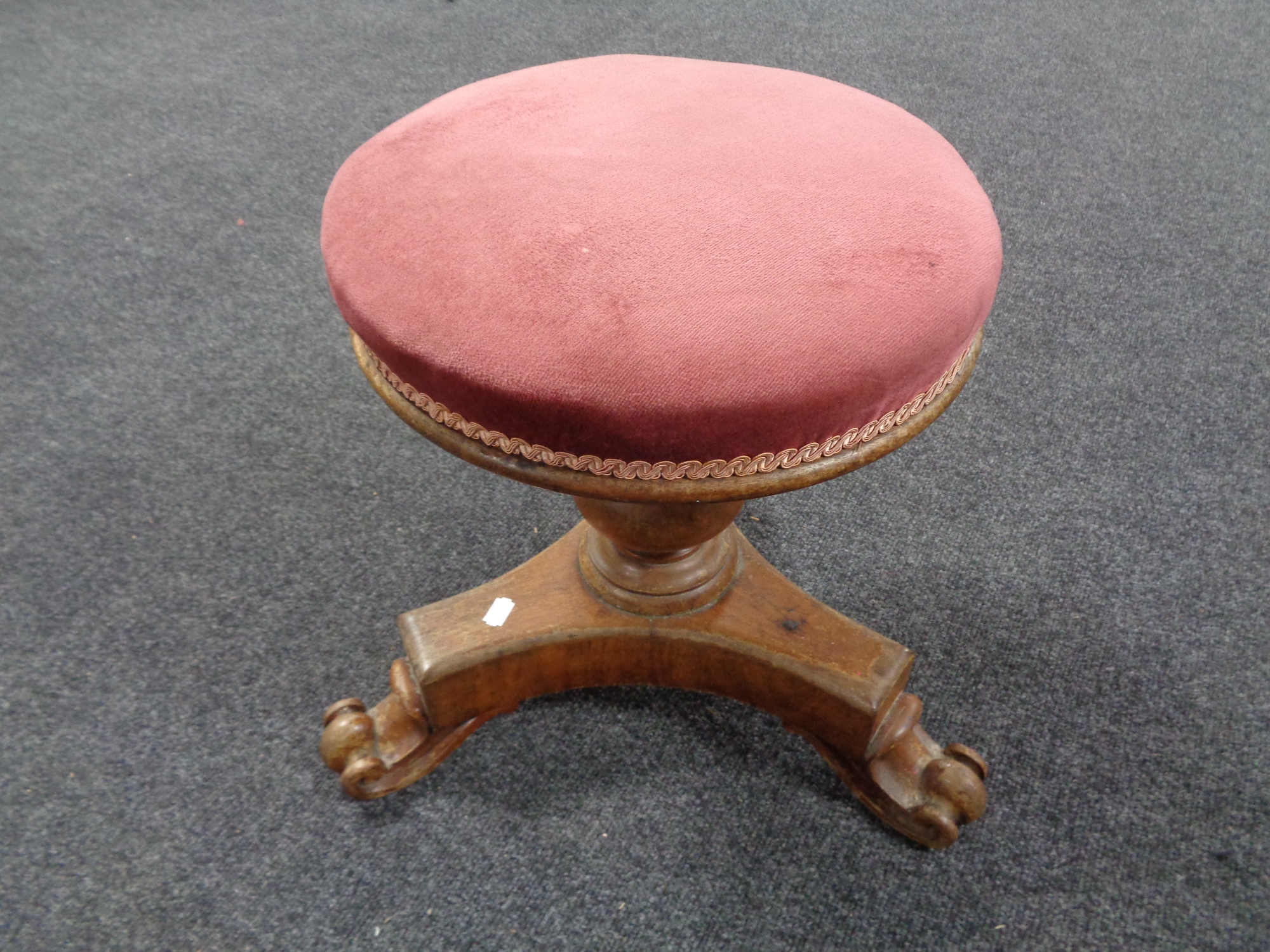 A Victorian mahogany circular revolving dressing table stool upholstered in a pink dralon.