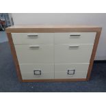 A good quality contemporary wood framed eight drawer chest with cream high gloss drawer fronts and