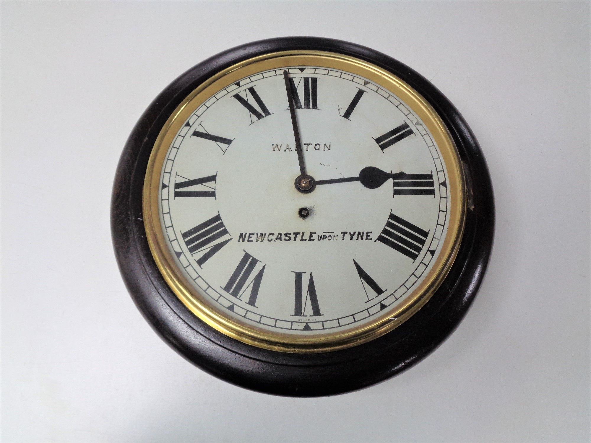 An early 20th century circular wall timepiece, later signed Walton,