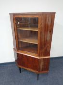 A mid 20th century rosewood glazed door corner display cabinet, fitted cupboard below,