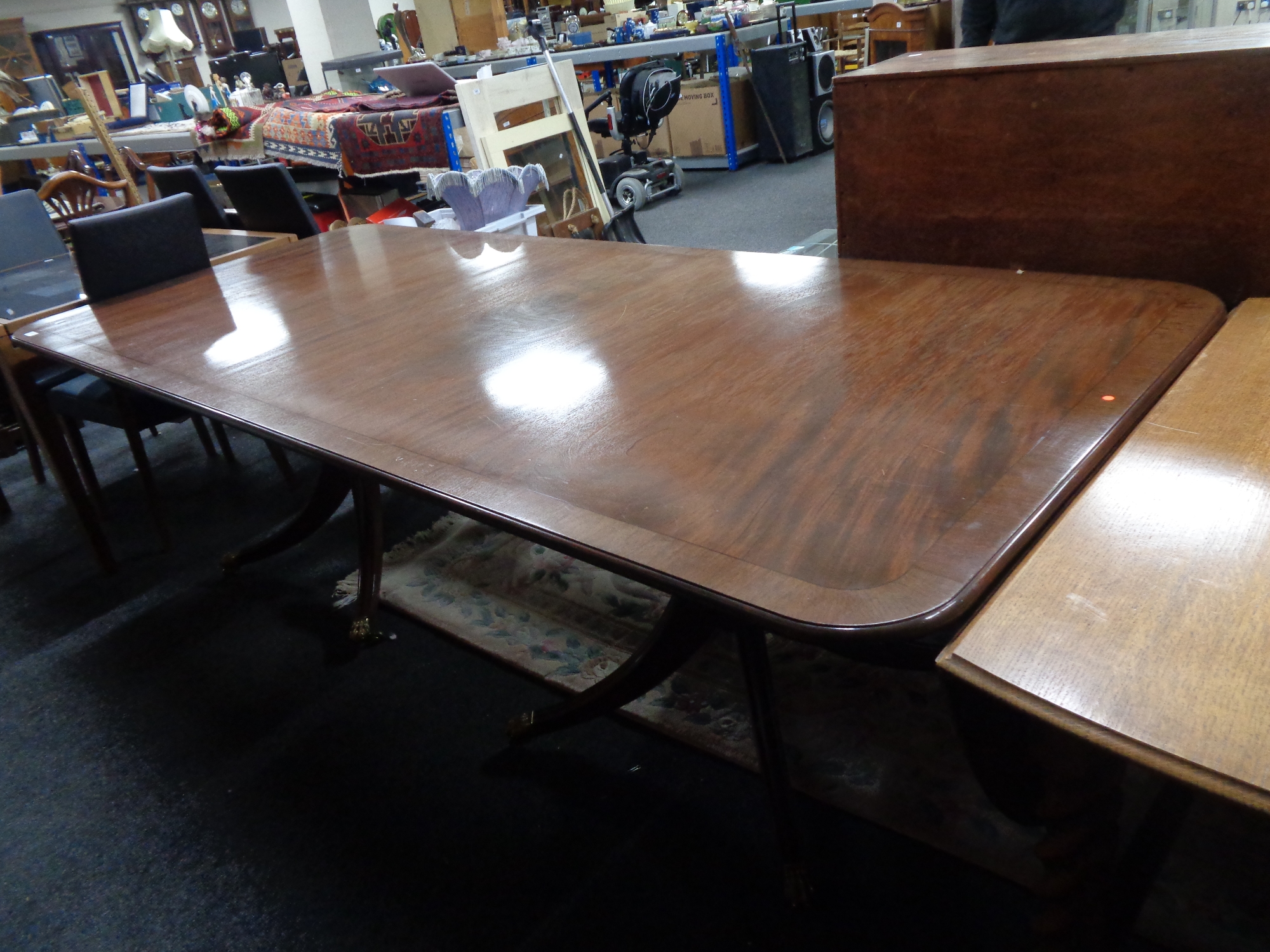 A Regency style inlaid mahogany twin pedestal dining table.