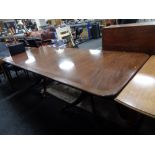 A Regency style inlaid mahogany twin pedestal dining table.