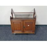 An Edwardian double door oak wall cabinet, fitted two internal drawers.