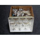 A box containing assorted glassware and metal ware to include tankards, cocktail shaker,