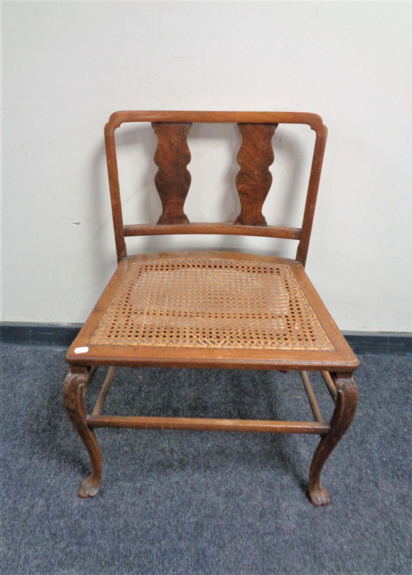 An Edwardian oversized dressing table chair with bergere seat.