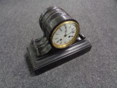 A late nineteenth century black slate mantel clock with circular enamel dial