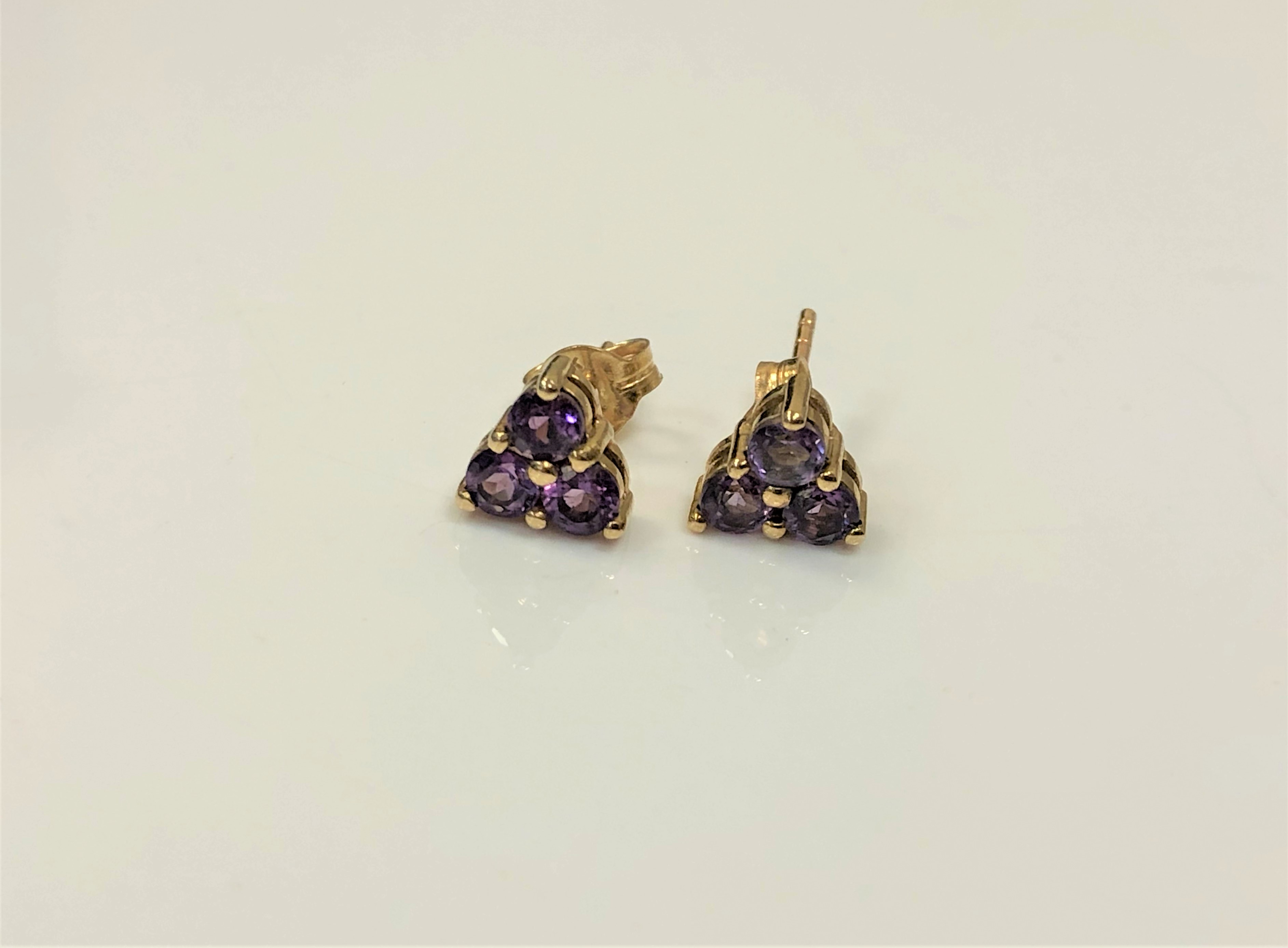 A pair of 9ct gold amethyst cluster earrings. CONDITION REPORT: 1.