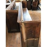 A two-section Gothic revival church pew, total length approximately 570 cm.