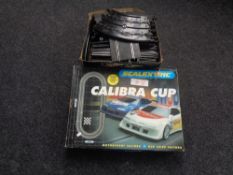 Two boxes containing Scalextric track together with a further box containing vintage and later