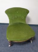 A Victorian nursing chair upholstered in green buttoned dralon