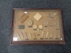 A display frame containing wooden plugs and bungs