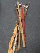 Nine assorted fishing rods in carry bags to include Daiwa split cane examples etc.