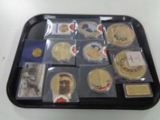 A tray containing a quantity of commemorative coins to include Saint George and the Dragon,