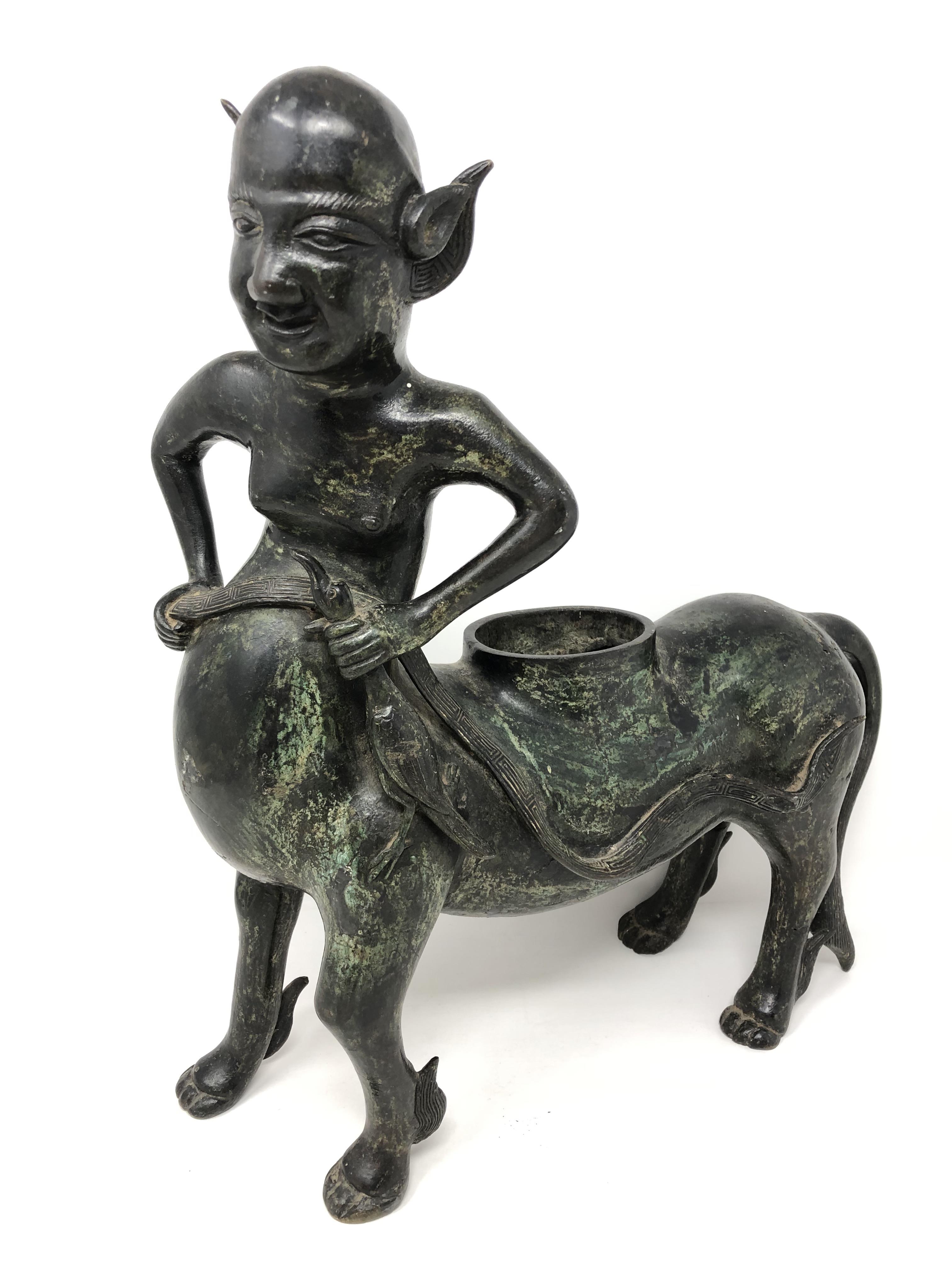 A South-East Asian patinated bronze censer in the form of a centaur-type creature with winged
