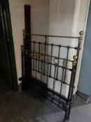 A 4' antique wrought iron and brass bed frame