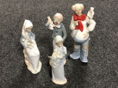 Two Lladro figures of girls with flowers (a/f) together with two further Cascade figures of clowns.