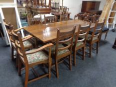 A good quality oak refectory dining table together with a set of eight ladder backed chairs (two