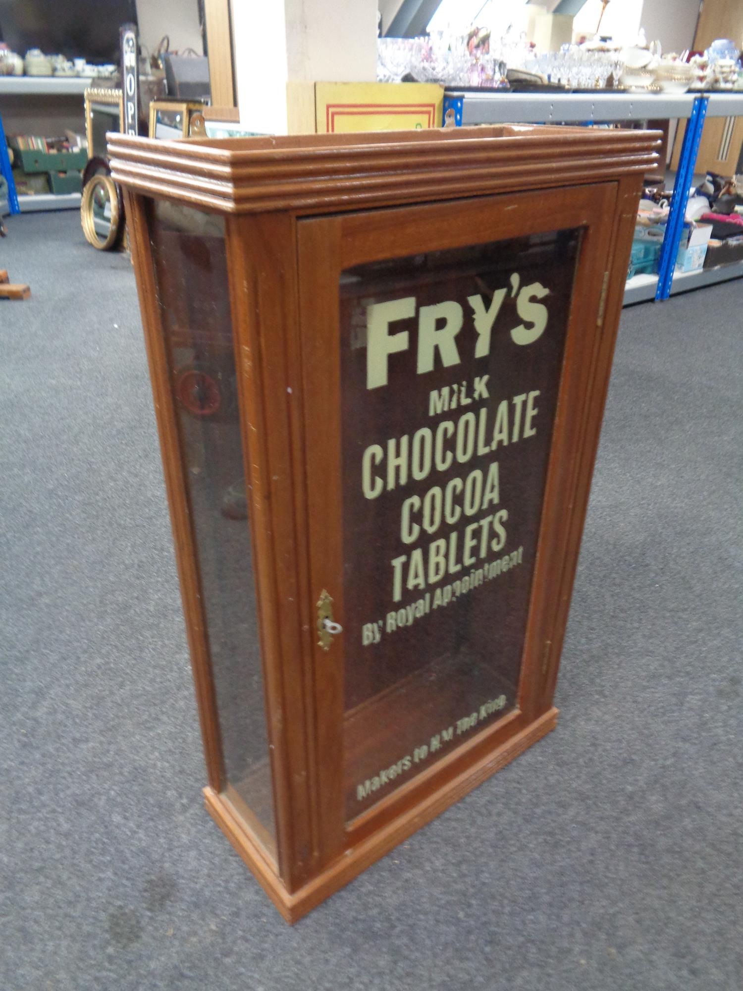 A wall mounted display cabinet bearing later Fry's Chocolate advertisement