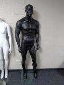 A male mannequin on stand (black).