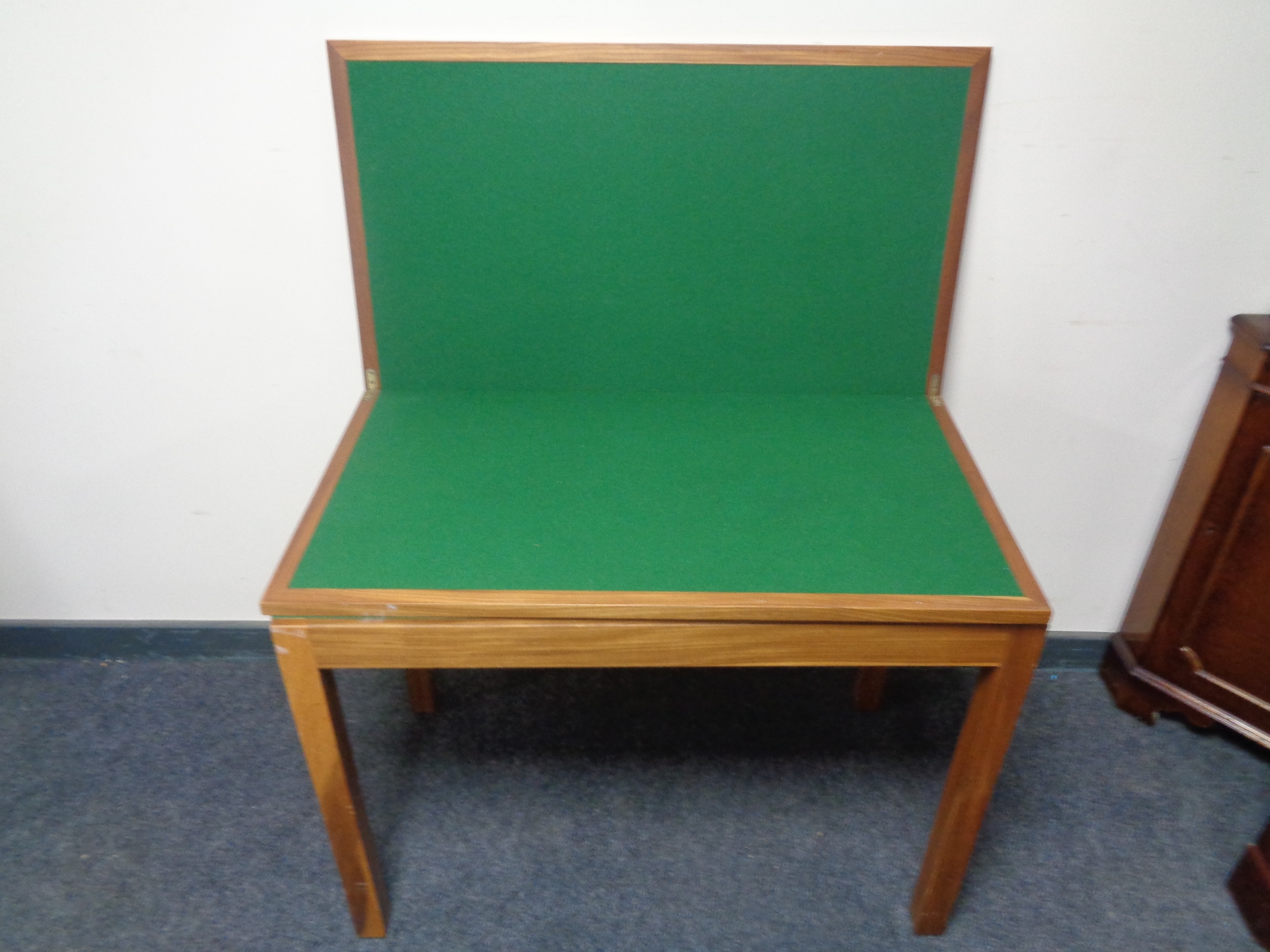 A twentieth century teak turnover top card table