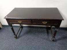 An Edwardian oak side table fitted with two drawers