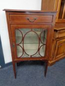 A late nineteenth century inlaid mahogany display cabinet fitted a drawer on raised legs