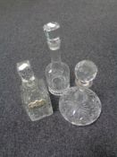 A tray containing three cut glass lead crystal decanters.