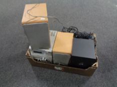 A box containing a Sony micro Hi-Fi system together with a Logitech computer speaker set.