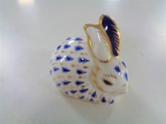 A Royal Crown Derby rabbit paperweight with silver stopper.